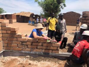 2019-11 Malawi building houses2 (boy in red shirt)